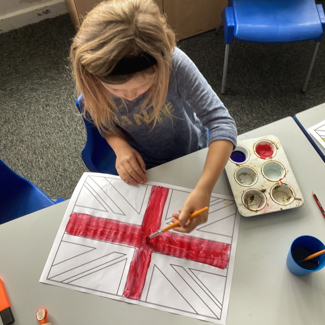 A pupil painting a union flag for VE day