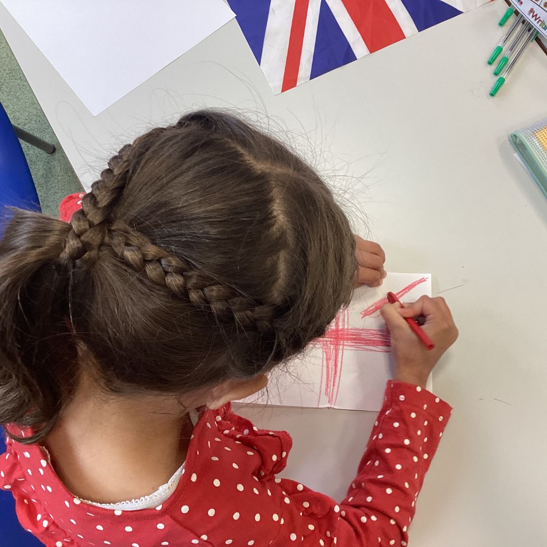 a pupil colouring in a union flag for VE day